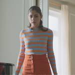 Sara’s blue and orange stripe sweater on Elite