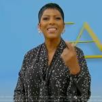 Tamron’s black star print tie neck blouse on Tamron Hall Show