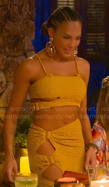 Amanza's yellow textured top and skirt with cutouts in Cabo on Selling Sunset