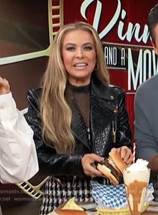 Carmen Electra’s black leather jacket and mini dress on Access Hollywood