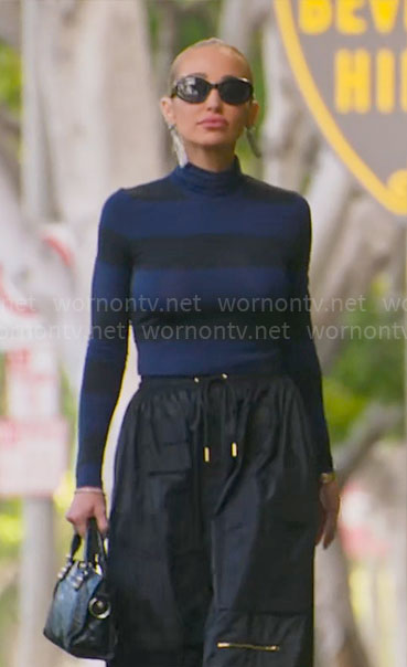 Mary's blue and black striped turtleneck with black cargo skirt on Selling Sunset