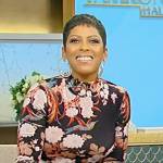 Tamron’s black floral print turtleneck top on Tamron Hall Show