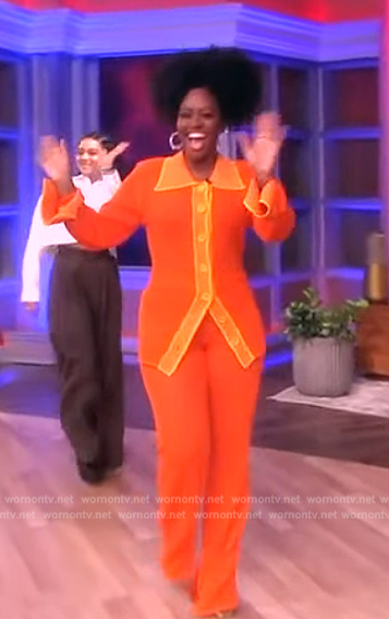 Teyonah Paris’ orange open knit top and pants on The View