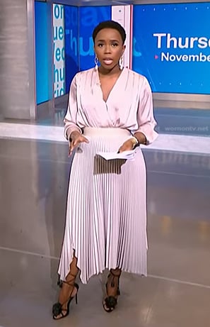 Zinhle’s pink satin wrap blouse and pleated skirt on NBC News Daily