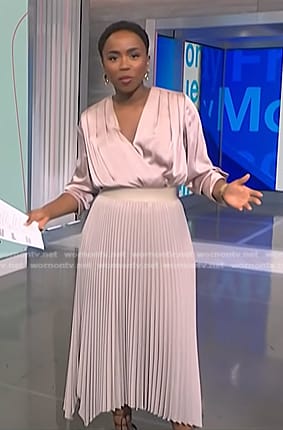 Zinhle's pink satin wrap blouse and pleated skirt on NBC News Daily