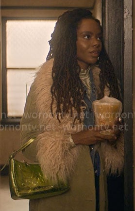 Hazel's green corduroy coat with fur collar, marble print top and metallic bag on The Other Black Girl