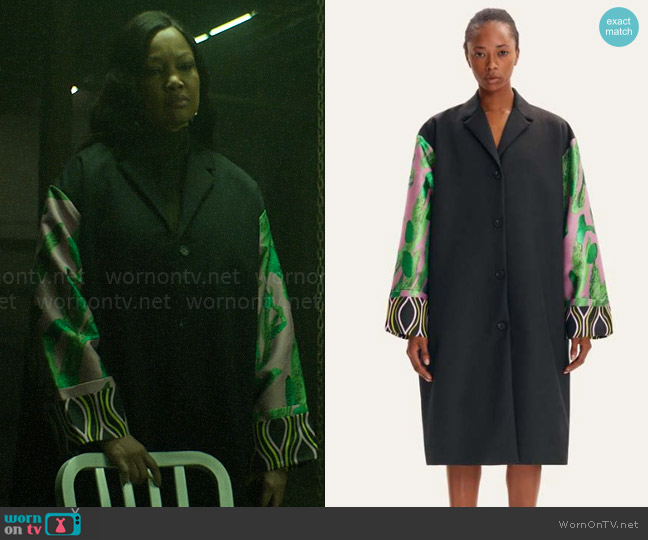Diana’s black coat with printed sleeves on The Other Black Girl