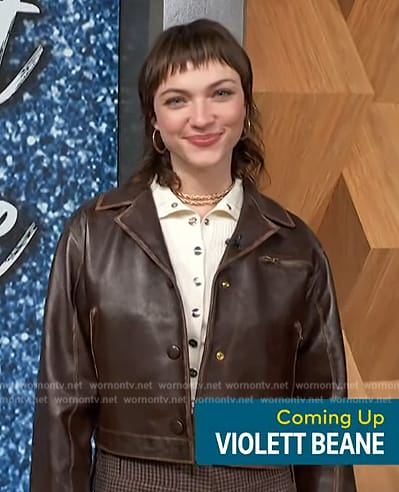 Violett Beane’s brown leather jacket and ribbed top on Access Hollywood