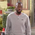 Malcolm’s grey striped trim sweatshirt on The Neighborhood