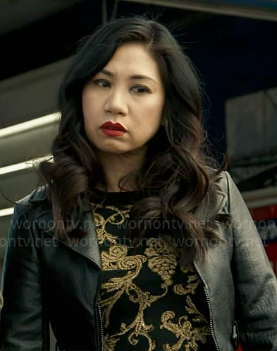 Mel's black and gold flourish print top and leather jacket on The Equalizer