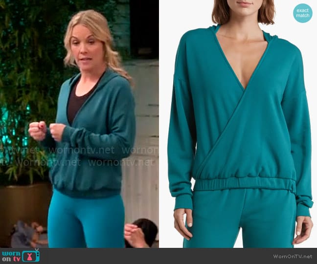 Kristen’s teal green cross front hoodie on Extended Family