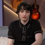 Finn Wolfhard’s black contrast trim polo on The Kelly Clarkson Show