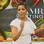 Tamron’s white lace-up top and floral pants on Tamron Hall Show