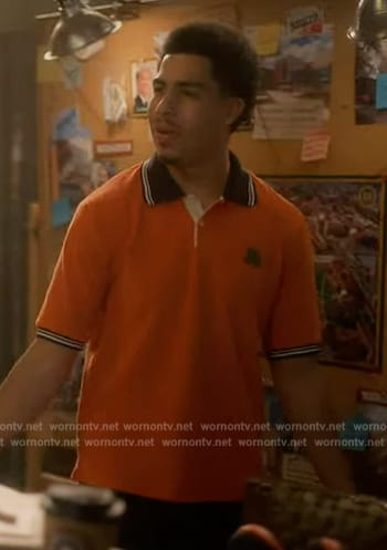 Aaron's orange polo on Grown-ish