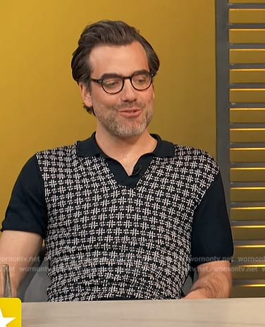 Daniel Ings’s black polo on Access Hollywood