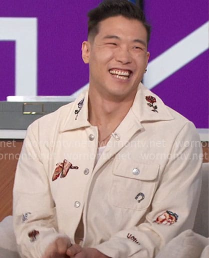 Joel Kim Booster’s jacket and pants with patches on The Talk