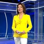 Norah's yellow blazer and white flare pants on CBS Evening News