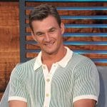 Tyler Cameron’s green stripe knit polo on Access Hollywood