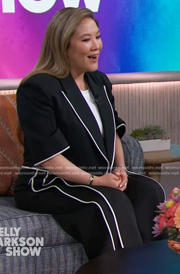 Ally Maki's black cropped blazer and pants with white piping on The Kelly Clarkson Show