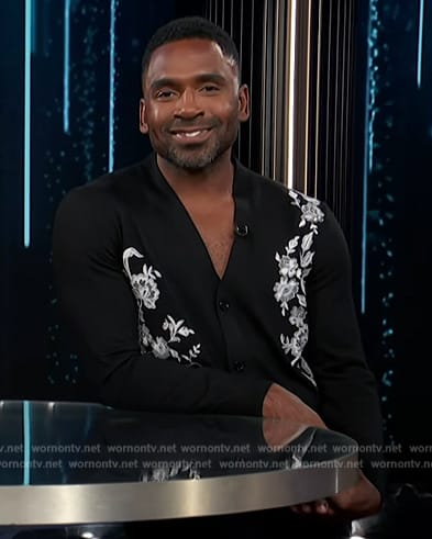 Justin’s black embroidered cardigan on E! News