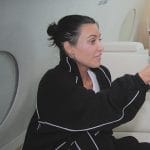 Kim’s black track jacket and pants on The Kardashians