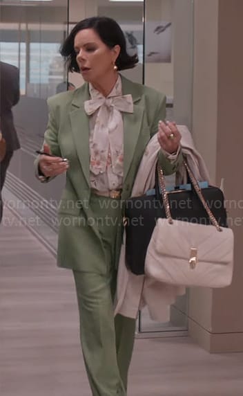 Margaret's floral tie neck blouse and green suit on So Help Me Todd