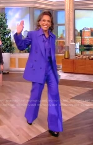 Sunny’s purple tie neck blouse and blazer on The View