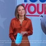 Eva’s orange satin shirt and brown belted pants on Good Morning America