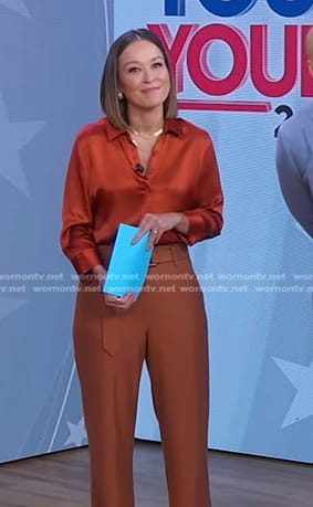 Eva’s orange satin shirt and brown belted pants on Good Morning America