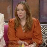 Mariah’s orange fringed wrap dress on The Young and the Restless