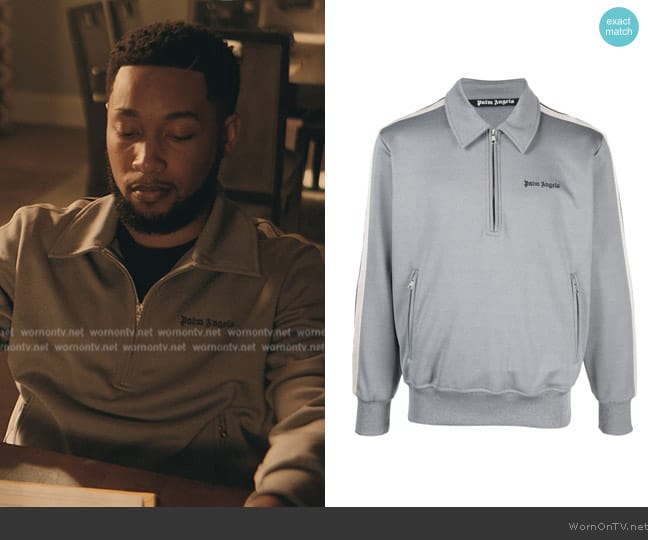 Emmett’s gray half zip sweater on The Chi