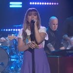 Kelly’s Stevie Nick graphic tee and purple skirt on The Kelly Clarkson Show