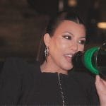 Kourtney’s black peplum jacket and mini skirt on The Kardashians