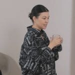 Kourtney’s black logo print shirt and pants on The Kardashians