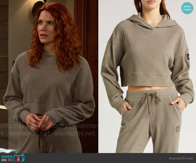 Alo Yoga Muse Rib Crop Hoodie in Olive Tree Heather worn by Sally Spectra (Courtney Hope) on The Young and the Restless