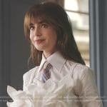 Emily’s white ruffle top and plaid tie on Emily in Paris