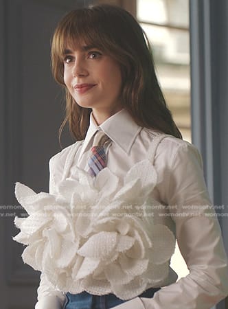 Emily's white ruffle top and plaid tie on Emily in Paris