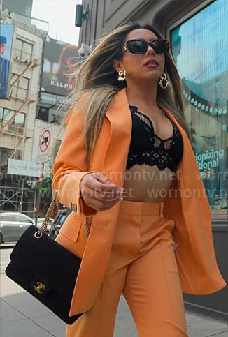 Jade's orange suit with black lace bra on Owning Manhattan