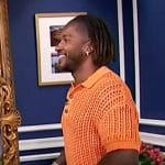 Scott’s orange open knit shirt on Access Hollywood