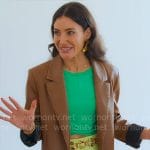 Chloe’s brown leather jacket with green mini skirt and gold accessories on Owning Manhattan