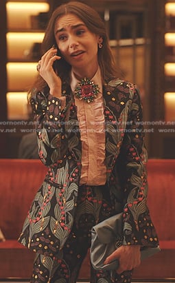 Emily's print suit and pink brooch on Emily in Paris