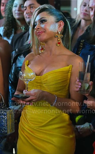 Jade's yellow strapless dress and face earrings on Owning Manhattan