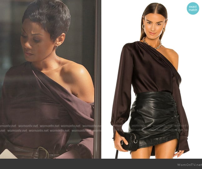 Jax’s burgundy one shoulder top on Reasonable Doubt