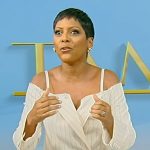 Tamron’s white pinstripe cold shoulder blazer on Tamron Hall Show