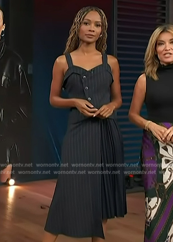 Zuri’s navy pinstripe top and pleated skirt on Access Hollywood