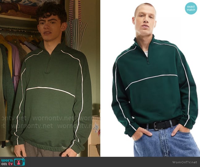 ASOS Design Oversized half zip sweatshirt with piping in dark green worn by Charlie Spring (Joe Locke) on Heartstopper