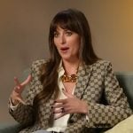 Dakota Johnson’s beige logo embroidered blazer on E! News