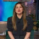 Kelly’s navy polka dot print tie neck dress on The Kelly Clarkson Show