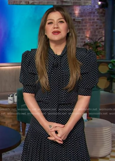 Kelly's navy polka dot print tie neck dress on The Kelly Clarkson Show