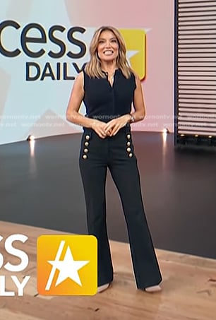 kit's navy knit top and black pants with gold buttons on Access Hollywood